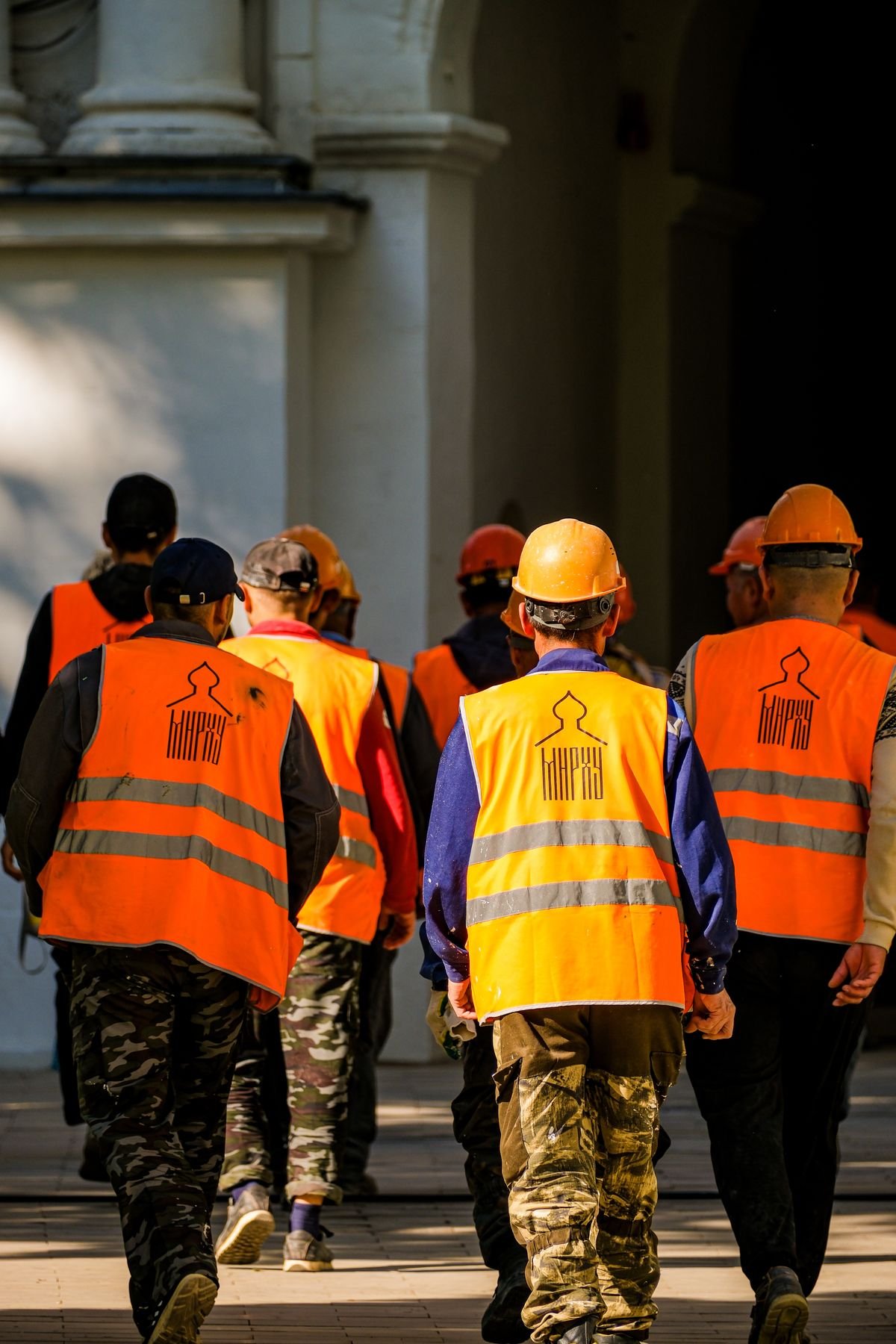 Construction workers wearing safety helmets and vests